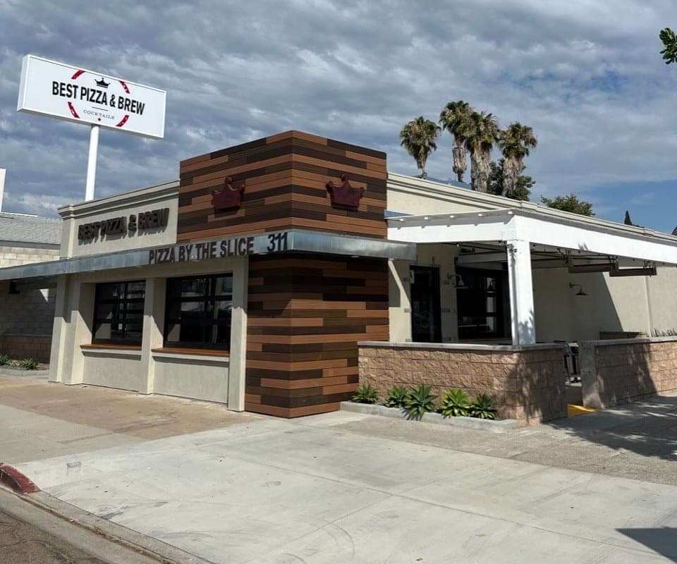 The Best Pizza & Brew Escondido storefront at 311 East Valley Parkway, with Pizza by the Slice signage on a wood-panelled facade