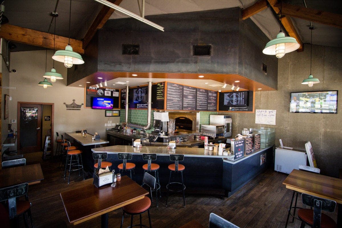 Inside the Mira Mesa restaurant, with counter seating and menu boards